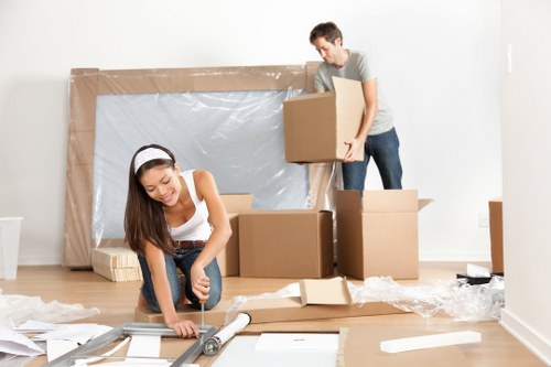 Flat removals team handling boxes in Kennington apartment building