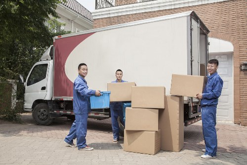 Removal company team loading household items for a booked move
