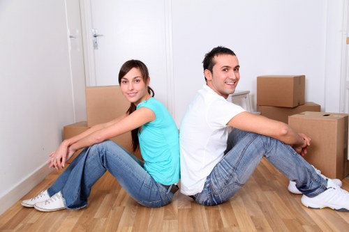 Staff carefully lifting and carrying furniture during a removal job