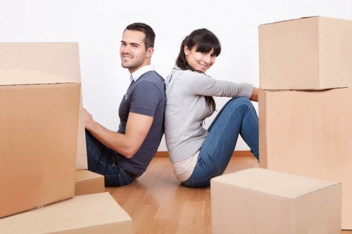 Professional movers packing and securing household items in Kennington