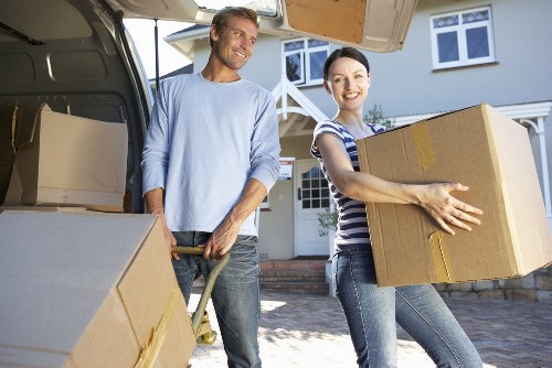 Professional removals crew handling packed household items in Kennington