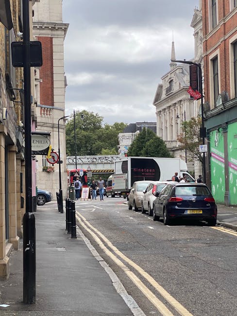 A rectangular white street sign mounted on a brick wall, displaying the text 'WELCOME TO SOUTH KENSINGTON SW7' in black and red lettering. The sign is affixed with four screws, one in each corner. The